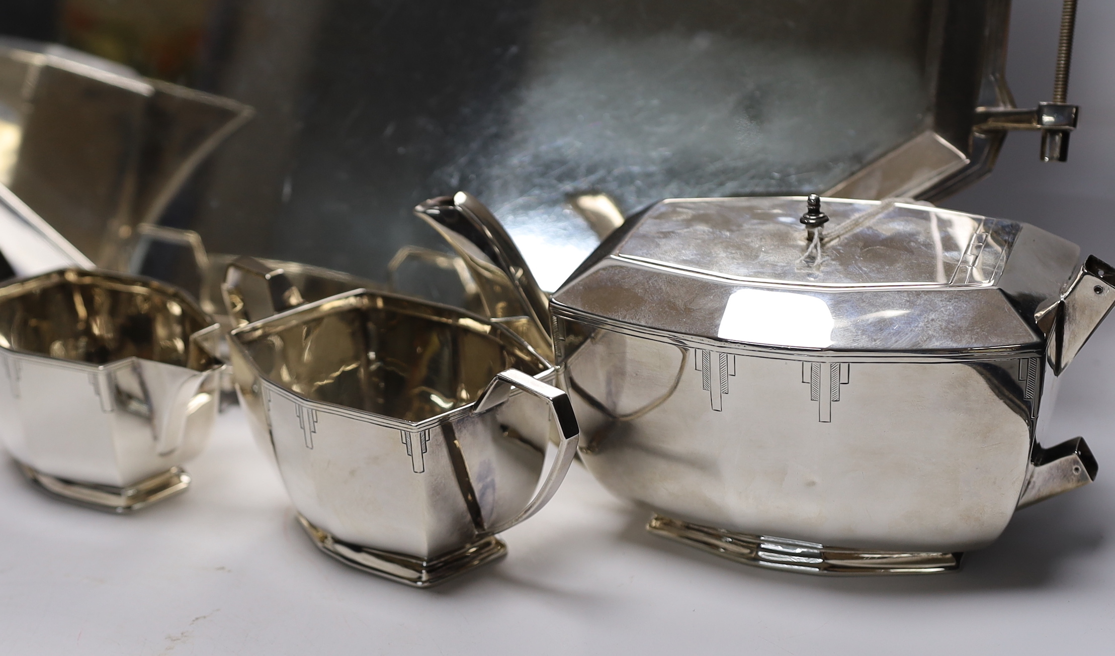A George V Art Deco silver four piece tea set with tea tray, by Viners Ltd, Sheffield, 1934/36, 114.5oz. (lacking handles)